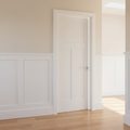 Bright hallway with solid pine 5-panel shaker door slightly ajar, white paint, brushed nickel lever handle